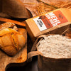 arrangement-dinkelvollkornmehl-mit-broetchen-und-mehlsack